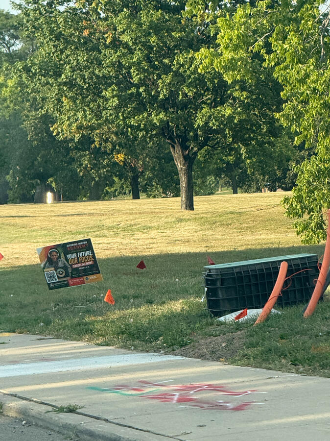65th and Portland Advertising sign on a street corner